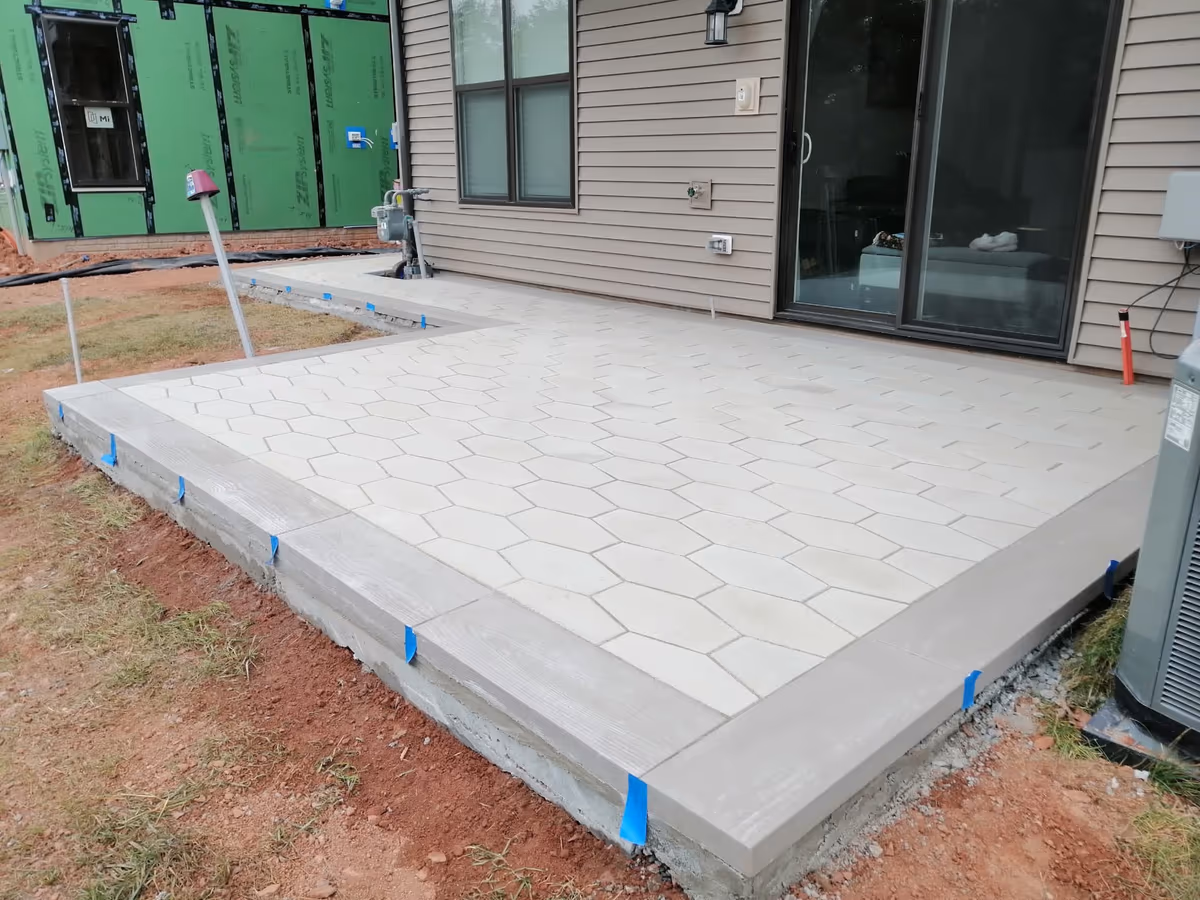 Finished stamped concrete patio with a stone pattern, poured off the back of a house